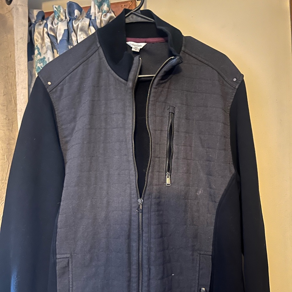 Size is large. Zip up Calvin Klein jacket